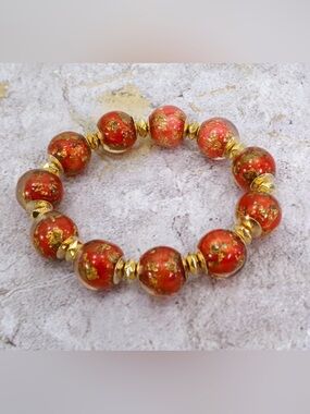 Red and gold bead stretch bracelet with gold leaf resin beads gold spacers New